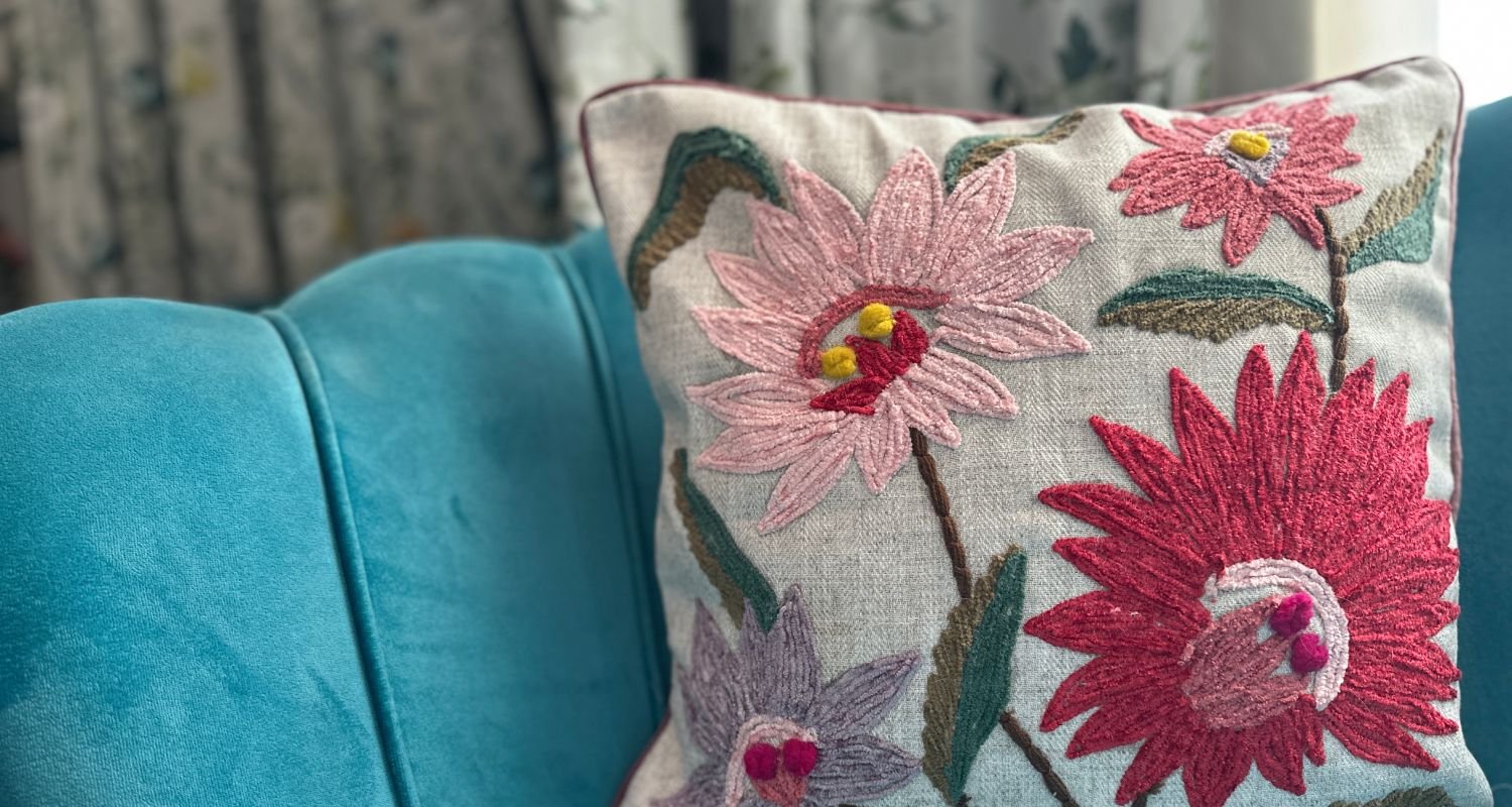 Botanical embroidered cushion cover on a living room sofa